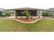 Lush backyard with healthy grass, mature landscaping, and a screened-in porch at 9607 Sw 79Th Lane Rd, Ocala, FL 34481
