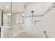 Bathroom featuring a spacious tiled walk-in shower with a rainfall showerhead and built-in bench at 9607 Sw 79Th Lane Rd, Ocala, FL 34481