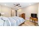 Cozy bedroom features a ceiling fan, warm lighting, and wood-look flooring at 9607 Sw 79Th Lane Rd, Ocala, FL 34481