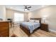 This comfortable bedroom features wood-look floors, ceiling fan and windows for natural light at 9607 Sw 79Th Lane Rd, Ocala, FL 34481