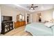 The Primary bedroom showcases a tray ceiling, a ceiling fan and wood-style flooring at 9607 Sw 79Th Lane Rd, Ocala, FL 34481