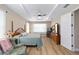 This primary bedroom features a tray ceiling, a ceiling fan and wood-look flooring at 9607 Sw 79Th Lane Rd, Ocala, FL 34481