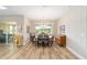 Bright dining room with large window, modern chandelier and backyard views at 9607 Sw 79Th Lane Rd, Ocala, FL 34481