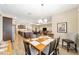 Open-concept dining room shows hardwood floors, chandelier, and adjoins the kitchen at 9607 Sw 79Th Lane Rd, Ocala, FL 34481