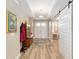 Bright foyer featuring beautiful floors, a coat rack, artwork and a sliding barn door to the living spaces at 9607 Sw 79Th Lane Rd, Ocala, FL 34481