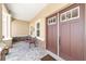 Close-up of the inviting front porch featuring stone pillars, seating, and a charming double door entrance at 9607 Sw 79Th Lane Rd, Ocala, FL 34481