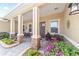 Inviting front porch with stone pillars, landscaping, and seating offering a relaxing outdoor space at 9607 Sw 79Th Lane Rd, Ocala, FL 34481