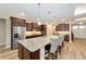 Gourmet kitchen with granite counters, stainless appliances, large island, and dark cabinets at 9607 Sw 79Th Lane Rd, Ocala, FL 34481