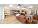 Open-concept living room features hardwood floors, ceiling fans, and access to the kitchen at 9607 Sw 79Th Lane Rd, Ocala, FL 34481