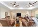 Comfortable living room featuring wood floors, a ceiling fan, and an inviting seating arrangement at 9607 Sw 79Th Lane Rd, Ocala, FL 34481