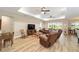 Spacious living room featuring wood floors, a trey ceiling with ceiling fans and a backyard view at 9607 Sw 79Th Lane Rd, Ocala, FL 34481