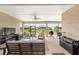 Comfortable screened-in porch with neutral furniture, ceiling fan, and views of the manicured backyard at 9607 Sw 79Th Lane Rd, Ocala, FL 34481