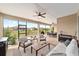 Spacious screened-in porch with modern furniture, ceiling fans, and an outdoor dining area with a grill at 9607 Sw 79Th Lane Rd, Ocala, FL 34481
