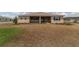 Exterior view of the backyard, with a view of the screened lanai and tidy landscaping at 9813 Sw 105Th Ct, Ocala, FL 34481