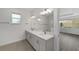 Bathroom featuring double vanity, modern fixtures, and tile flooring at 9813 Sw 105Th Ct, Ocala, FL 34481