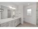 Bright bathroom with a wide mirror, double sinks, white countertops and tile floors at 9813 Sw 105Th Ct, Ocala, FL 34481