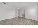 Large bright bedroom featuring white walls and wood-look floors with doorways visible at 9813 Sw 105Th Ct, Ocala, FL 34481