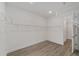 Walk-in closet featuring wood-look floors, bright white walls, and wire rack shelving at 9813 Sw 105Th Ct, Ocala, FL 34481