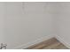 Walk-in closet with wire rack shelving and wood-look flooring at 9813 Sw 105Th Ct, Ocala, FL 34481