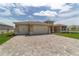 Beautiful single-story home with a three-car garage and a brick driveway at 9813 Sw 105Th Ct, Ocala, FL 34481