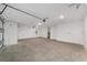 Spacious garage featuring an automatic door and concrete flooring at 9813 Sw 105Th Ct, Ocala, FL 34481