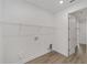 Bright laundry room equipped with hookups and shelving at 9813 Sw 105Th Ct, Ocala, FL 34481
