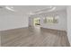 Open living space with a sliding glass door, recessed lighting and light wood-look flooring at 9813 Sw 105Th Ct, Ocala, FL 34481