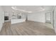 Bright living space featuring recessed lights, wood floors, and a seamless connection to the kitchen at 9813 Sw 105Th Ct, Ocala, FL 34481