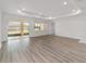 Expansive living room boasting wood floors, recessed lighting, and sliding glass doors at 9813 Sw 105Th Ct, Ocala, FL 34481