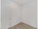 Well-lit room featuring wood-look floors and a white door at 9813 Sw 105Th Ct, Ocala, FL 34481