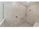 Walk-in shower featuring floor-to-ceiling tile, a built-in seat, and modern fixtures at 9813 Sw 105Th Ct, Ocala, FL 34481