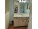 Bathroom featuring a vanity with cabinet storage, sink, and a large mirror over the sink at 10269 Sw 63Rd Ave, Ocala, FL 34476
