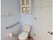 Bathroom with toilet, grab bars, tiled floors, and above toilet storage cabinet at 10269 Sw 63Rd Ave, Ocala, FL 34476