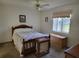 Cozy bedroom with a wooden bed, carpet floors, a ceiling fan, and natural light at 10269 Sw 63Rd Ave, Ocala, FL 34476
