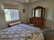 Bedroom with carpet floors, a wooden dresser, and natural light at 10269 Sw 63Rd Ave, Ocala, FL 34476