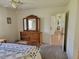 Bedroom featuring a wooden dresser and a view to an adjacent room at 10269 Sw 63Rd Ave, Ocala, FL 34476