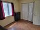 Bedroom featuring laminate wood floors, a dresser, closet, and natural light at 10269 Sw 63Rd Ave, Ocala, FL 34476