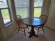 Breakfast nook featuring a glass table, two chairs, and natural light from surrounding windows at 10269 Sw 63Rd Ave, Ocala, FL 34476
