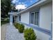 Exterior view of a one-story home with trimmed shrubs and a white gravel border at 10269 Sw 63Rd Ave, Ocala, FL 34476