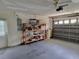 Spacious two-car garage equipped with an automatic door opener and ample storage shelving at 10269 Sw 63Rd Ave, Ocala, FL 34476
