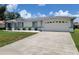 Single story home with a two-car garage and an extra wide driveway at 10269 Sw 63Rd Ave, Ocala, FL 34476