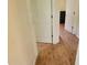 Hallway featuring wood look floors, doorframes, and access to other rooms in the house at 10269 Sw 63Rd Ave, Ocala, FL 34476