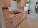 Kitchen featuring wood cabinets, stainless steel sink, tiled floors, and modern appliances at 10269 Sw 63Rd Ave, Ocala, FL 34476