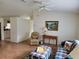 Open living room featuring wood-look flooring, ceiling fan, and a comfortable seating arrangement at 10269 Sw 63Rd Ave, Ocala, FL 34476