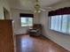 Bright living room featuring hardwood floors, natural light, and a comfortable armchair at 10269 Sw 63Rd Ave, Ocala, FL 34476