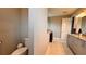 Stylish bathroom featuring gray cabinets, granite counters, and tile floors, complemented by a glass-enclosed shower at 10287 Sw 96Th Ln, Ocala, FL 34481