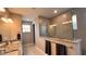 Modern bathroom showcasing sleek design with glass shower enclosure, granite countertops and warm lighting at 10287 Sw 96Th Ln, Ocala, FL 34481