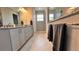 Elegant bathroom features double vanity with granite counters, glass shower, and warm lighting creating a luxurious space at 10287 Sw 96Th Ln, Ocala, FL 34481