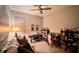 Cozy bedroom with a ceiling fan, a piano, and an array of bookshelves and decor at 10287 Sw 96Th Ln, Ocala, FL 34481