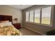 Bright bedroom features a window with shutters and tropical-themed bedding and furniture at 10287 Sw 96Th Ln, Ocala, FL 34481